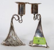 A pair of contemporary sterling silver hallmarked candlestick holders in the Archie Knox style.