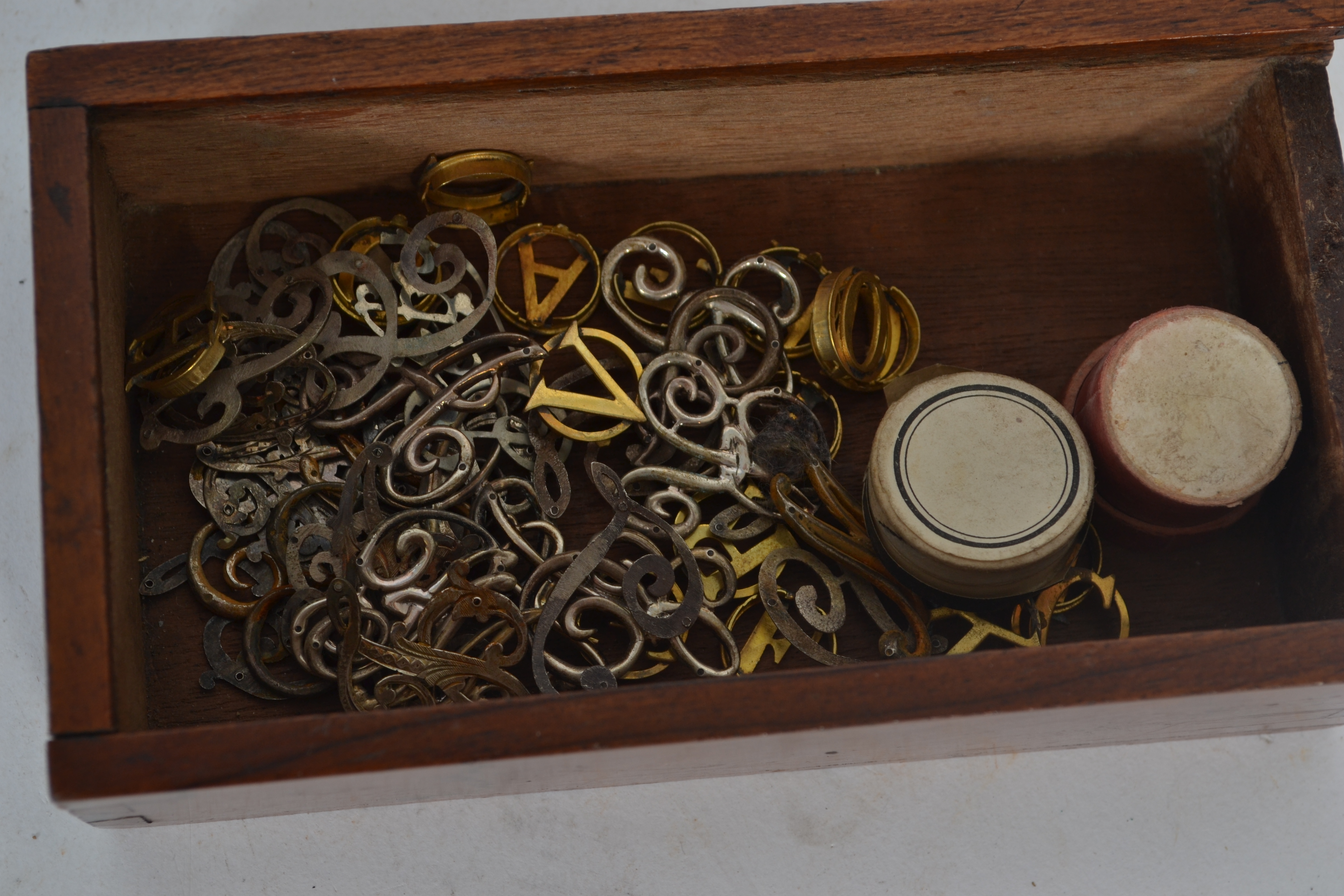 A collection of monogram silver and 9ct gold plated letters used for bookbinding, some tested as