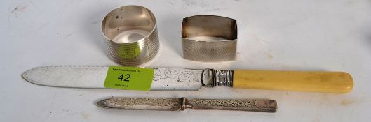 A hallmarked sterling silver napkin rings, along with a silver coloured knife and a Western Super