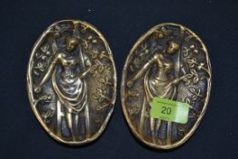 Two brass erotic pin trays having maidens to bowls, with naked rears to verso.
