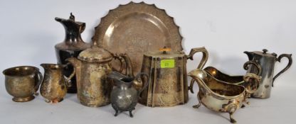 A collection of silver plate items to include gravy boats, teapots, tray, and other items