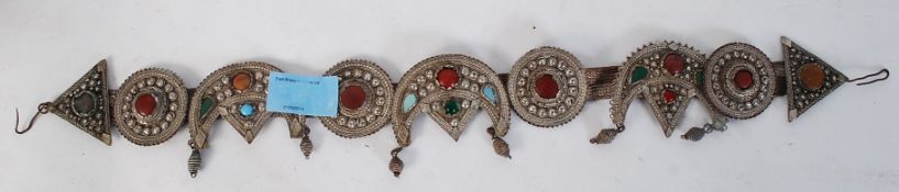 A white Indian Silver metal head belt/band with inset stones.
