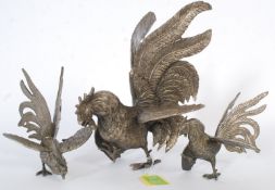 A set of three 20th century cast metal fighting cocks / chickens