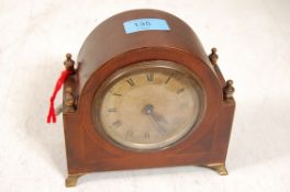 An inlaid mahogany mantel clock with brass finial`s and feet