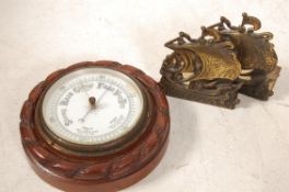 A vintage oak circular aneroid barometer having rope gadrooned edge together with a pair of brass