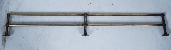 A 19th century Victorian brass towel rail of tubular construction with finials to each end