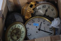 A box of assorted clock parts to include faces, movements etc