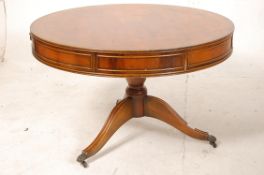 A Regency style yew wood drum table / coffee / occasional table. Raised on a tripod base with drum