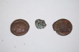 Two Roman coins together with a similar old coin.