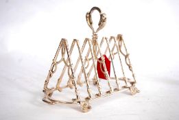 Silver plated toast rack standing on four fox heads.