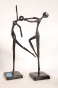 Two Bronze cold painted black modern figurines of dancers raised on plinth bases.
