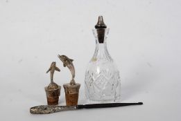 Two Silver (tested) bottle stoppers with Dolphin tops, A silver handled crochet hook, Silver