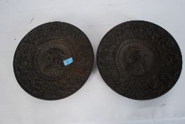 A pair of 19th century Portuguese bronze wall plaques of circular form cast in low relief having