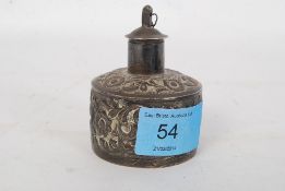 An Indian silver (tested silver) white metal perfume bottle with removable lid.