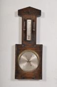 A 1930`s large oak case square wall barometer having circular face with thermometer having