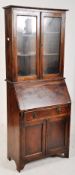 A 1930`s oak student bookcase bureau. The base having fold down slope with appointed interior