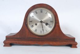 A 1930`s oak cased mantel clock. The dome top having central silvered dial with movement behind