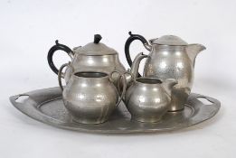 A mid 20th century pewter Arts & Crafts service comprising a good sized salver tray, teapot, coffee