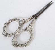 A pair of Victorian silver chase decorated scissors ( tested as silver)