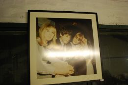 MEMORABILIA: A large framed photograph of The Beatles` Paul McCartney signing autographs.