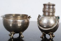 Sterling silver pepper pot and salt each with handle and stood on four cabriole style feet. Marked