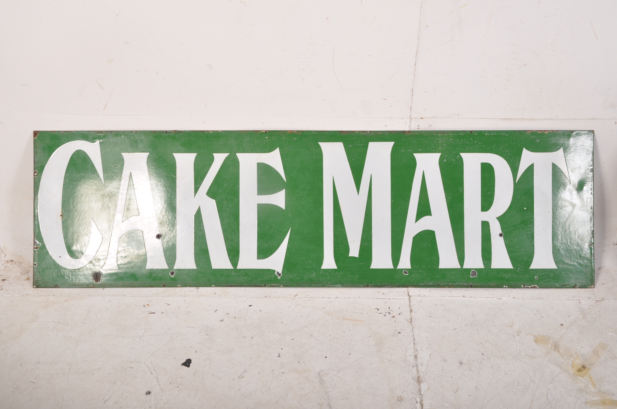 A very large late 19th century early 20th century enamel advertising sign for Cake Mart. The vivid