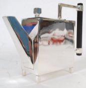 A Christopher Dresser style silver plate angular Art Deco teapot, standing on small square box