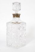 A hallmarked sterling silver banded cut glass decanter with stopper - hallmarks to band.