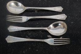 A pair of Edwardian sterling silver forks together with matching spoons decorated with acanthus