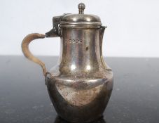 A Victorian sterling silver Gurnsey Jug with rattan woven lined handle. Hallmarked London 1885 for