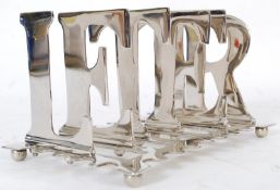 A 20th century silver plated letter rack, with each compartment constructed to a letter of the