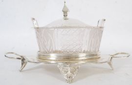A silver plate and glass lidded butter dish