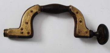 A Victorian ebony and brass mounted William Marples ``ULTIMATUM`` brace, the head screw with horn