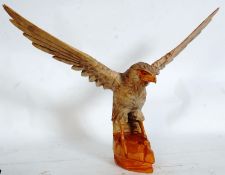 A Russian 20th century wooden eagle raised on naturalistic plinth