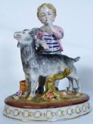 Ceramic figure of a young child with a goat.