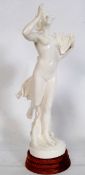 A large 20th century figurine of a nude woman in the neo classical style playing the lyre / harp