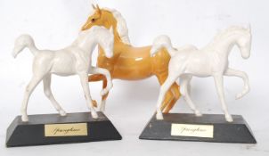A collection of three Beswick horses, one a palimino the others on plinth bases