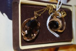 A yellow gold metal (stamped 375 (marks obscured)) smoked quartz pendant necklace, along with a