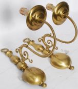 A pair of brass Victorian style brass wall lights sconces in the rococo style having scrolled arms