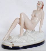 An Art Deco Royal Dux seated / reclining nude by Elly Strobach with raised hands being on a cloud