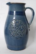 An unusual 20th century stoneware jug having celtic knot embellished design having decorative
