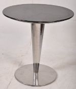 A 1930`s Art Deco chrome cafe table. The inverse tapered column on circular base with ebonised top