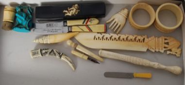A collection of bone and ivory wares to include paper knife, napkin rings, cheroot, intaglios,