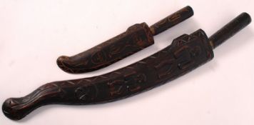 A vintage carving set with knife sharpener, along with two carved hardwood cased decorative knives.