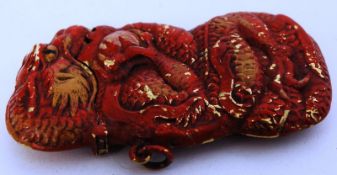 A pressed metal hand painted dragon match vesta