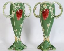 A pair of Eichwald secessionist vases having shaped bases wtih pierced arches, waisted bodies  and