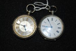 Two vintage white silver metal (marked `fine silver`) pocket watches with embossed case and enamel