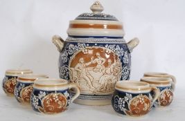 A 20th century large German stein ware punch set comprising of a large rumptoff together with the 6