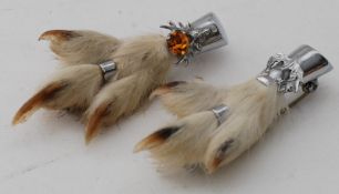 A pair of Scottish silver talon brooch, formed from talond. The silver mounts with amber stonesand