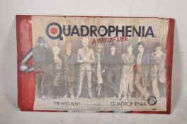 A large quad sized Quadrophenia poster being mounted onto a graffiti board